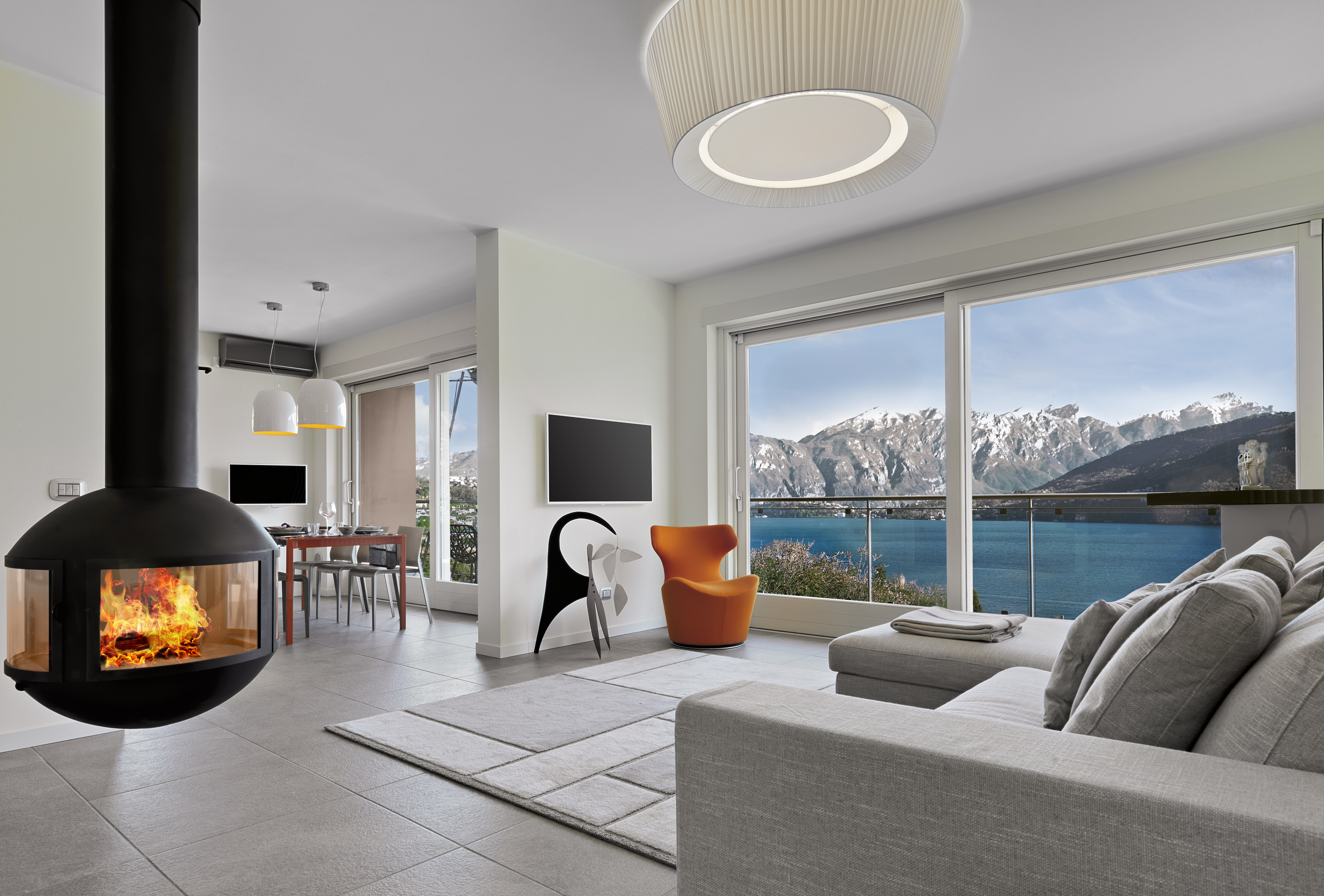 modern living room interior with iron fireplace overlooking Lake Como
